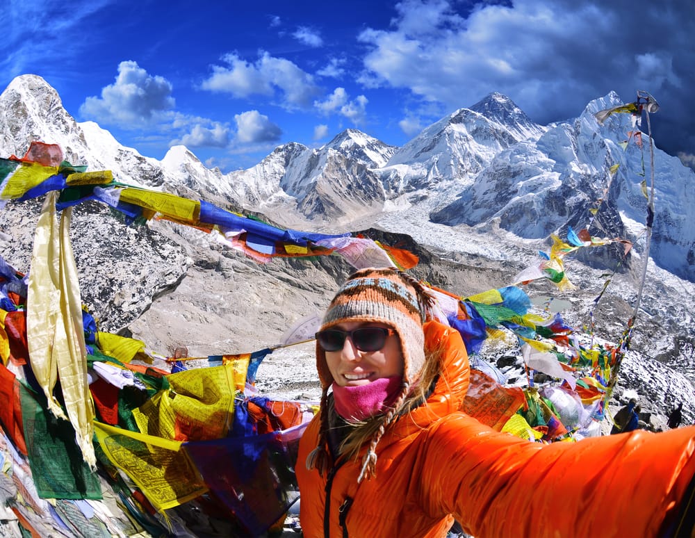 Adventure traveler takes selfie on mountain peak Kala Patthar in Nepal