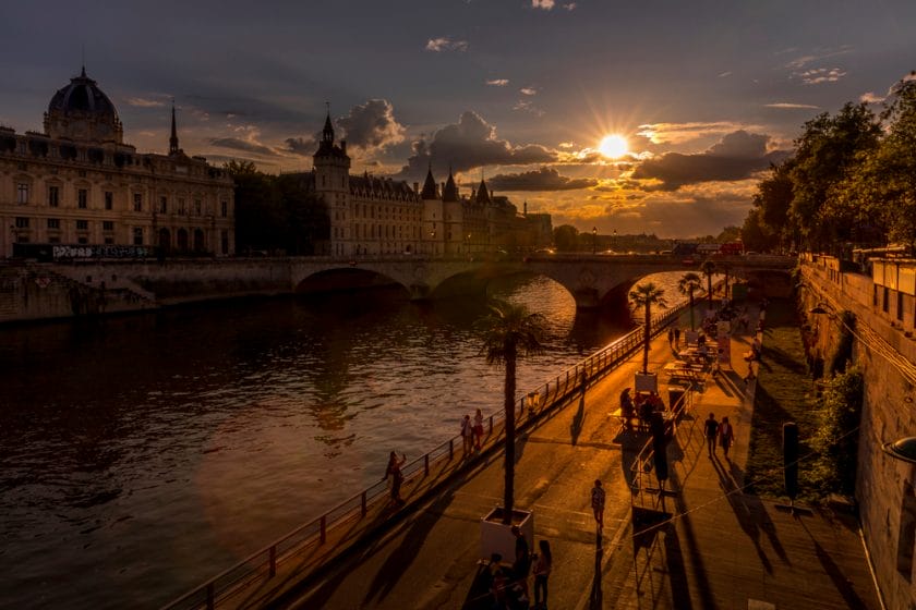 Parisians walking along the Seine river at sunset Free Activities in Paris