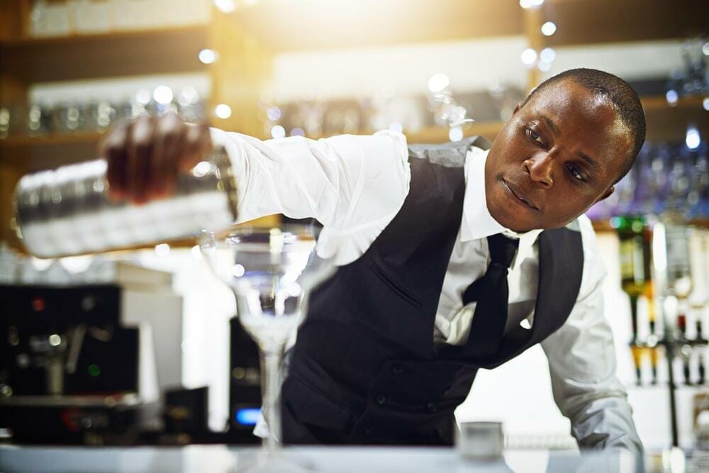 Bartender mixing drinks behind the bar