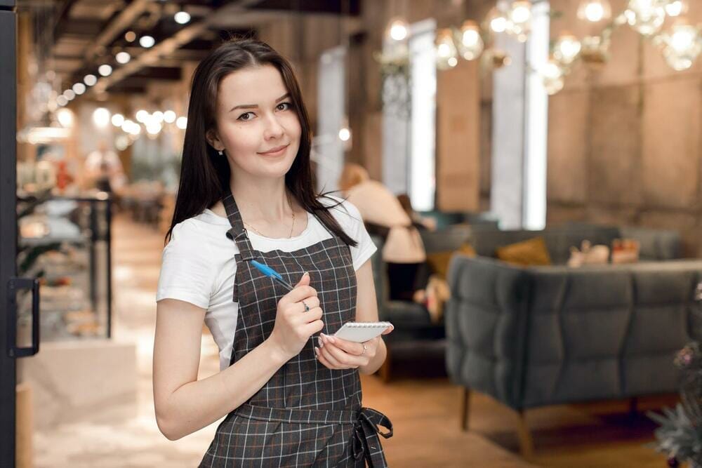 Waitress writing food order on her notepad